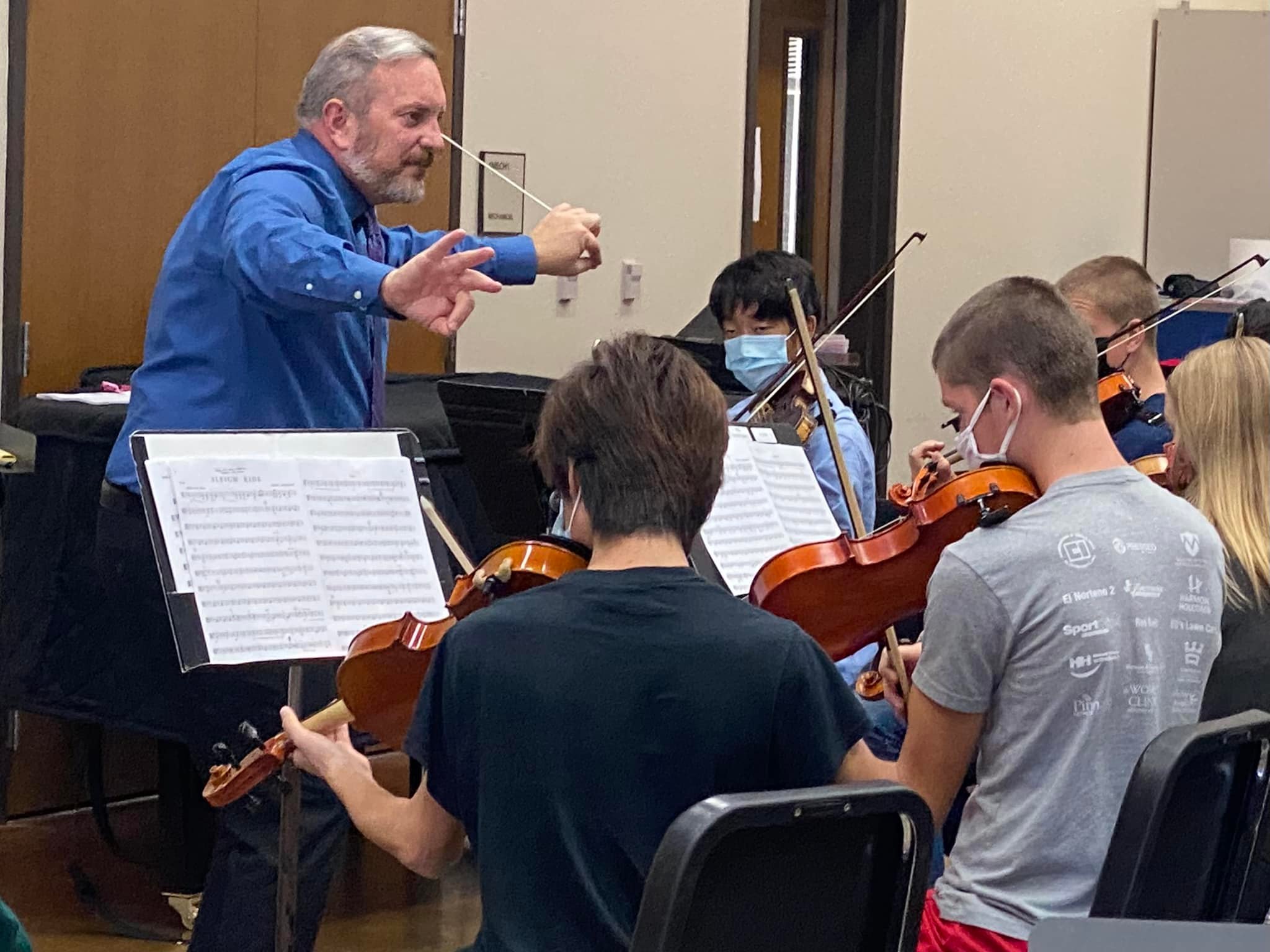 youth orchestra conductor at rehearsal